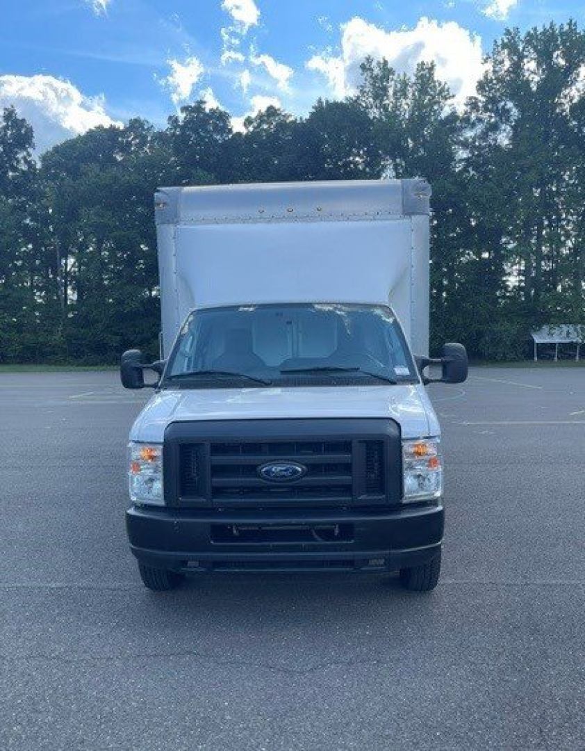 Front view of a 2019 Ford E-Series Cutaway truck with a box rear cargo area, black grille, and side mirrors in view.