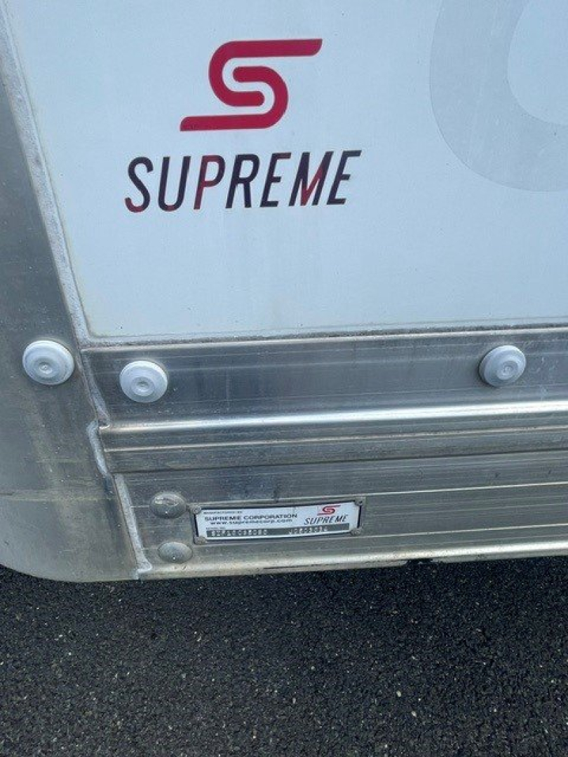 Back of a Ford E-Series Cutaway truck with Supreme logo and manufacturer plate. Visible text includes SUPREME and small metal plate with VIN/barcode details.