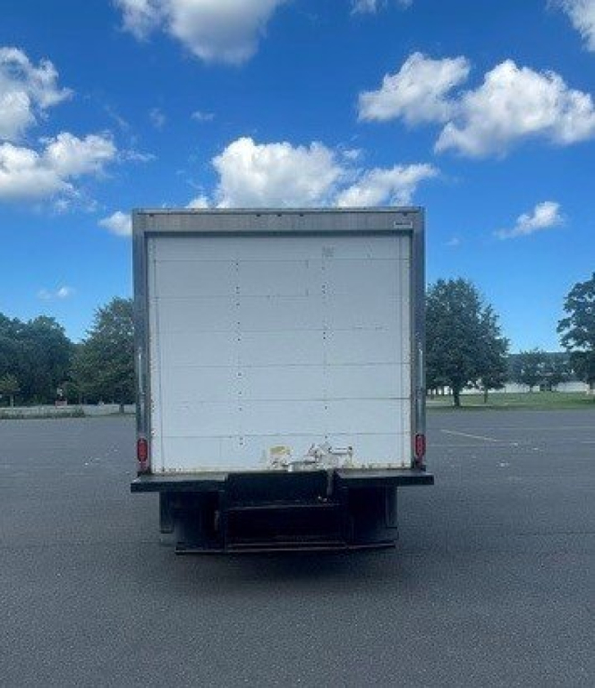 Rear view of a 2019 Ford E-Series Cutaway cab chassis truck with a box cargo area, white back door, and bumper area visible.