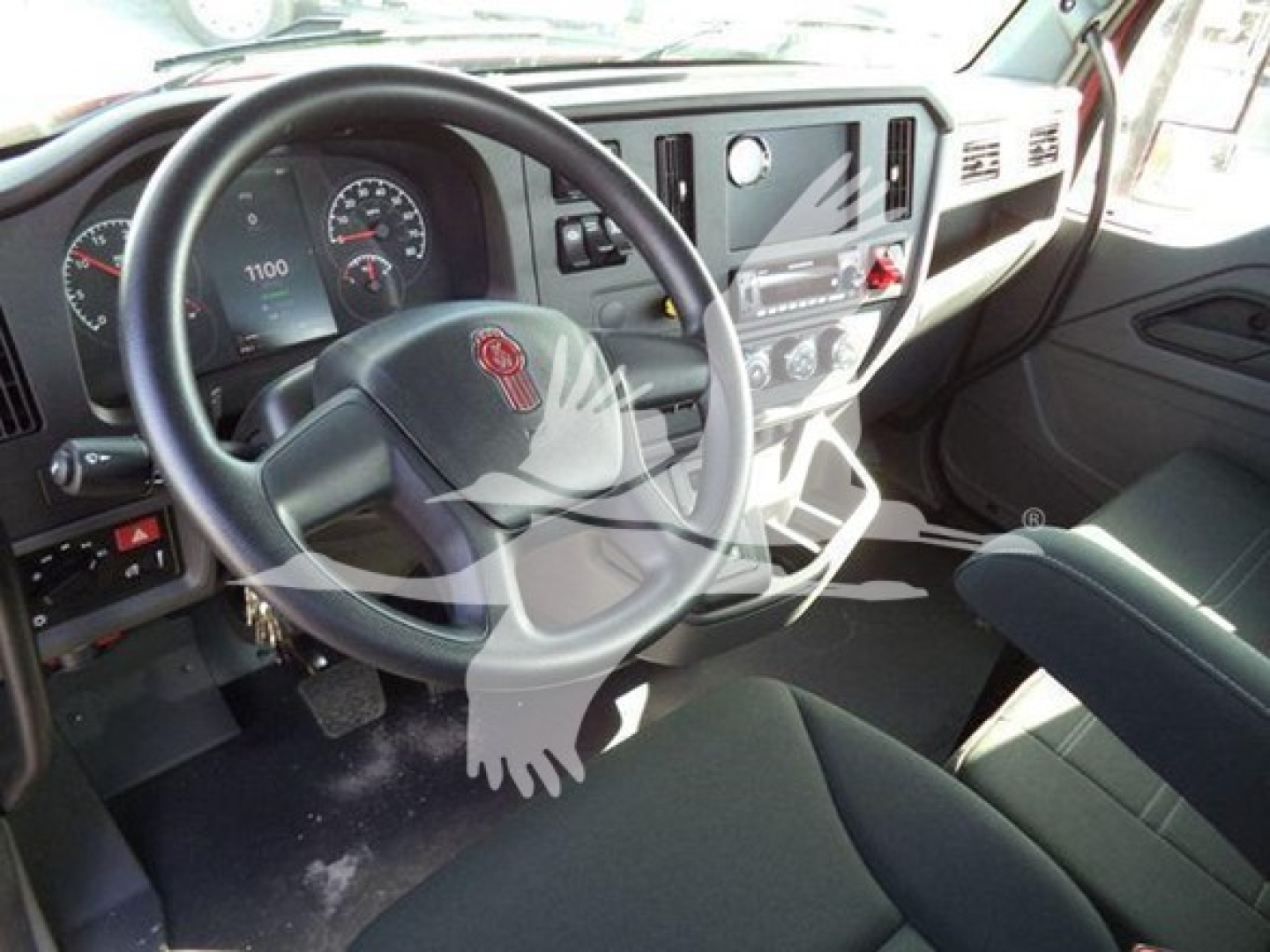 Kenworth T280 cab interior showing steering wheel and dashboard with gauges and control panel.