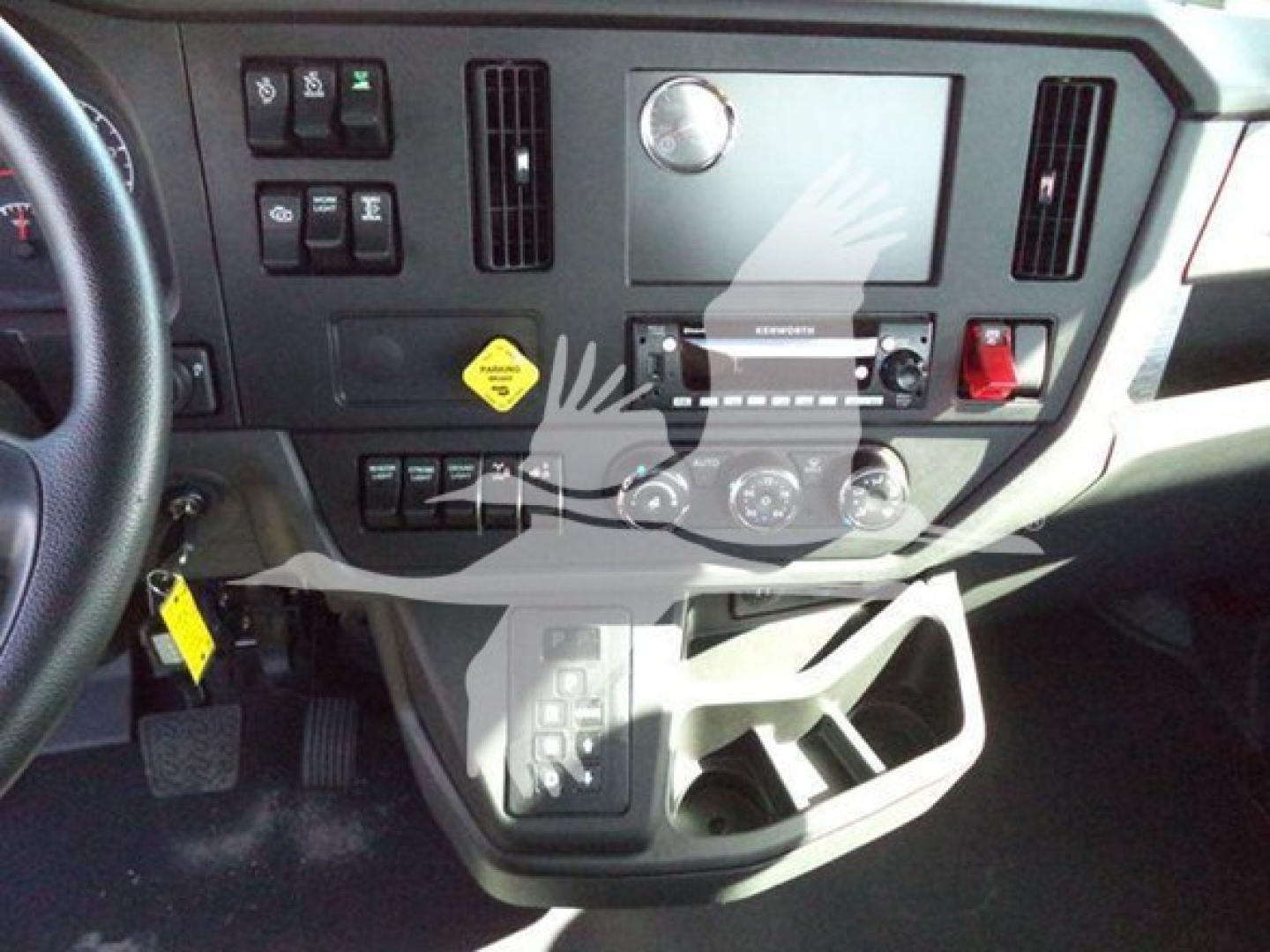 Kenworth T280 dashboard view showing center control panel and cup holder area.