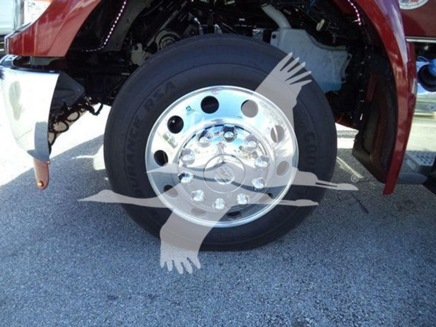 Kenworth T280 front wheel and fender showing polished steel wheel and tire.
