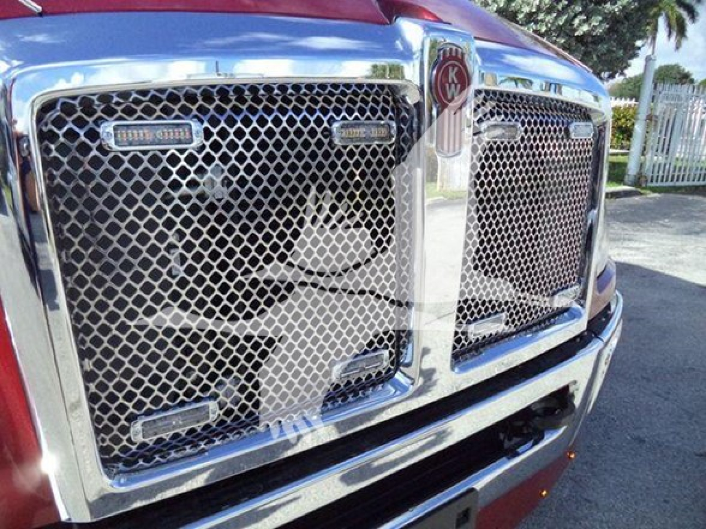 Kenworth T280 grille close-up showing chrome mesh, Kenworth emblem, and badge areas.