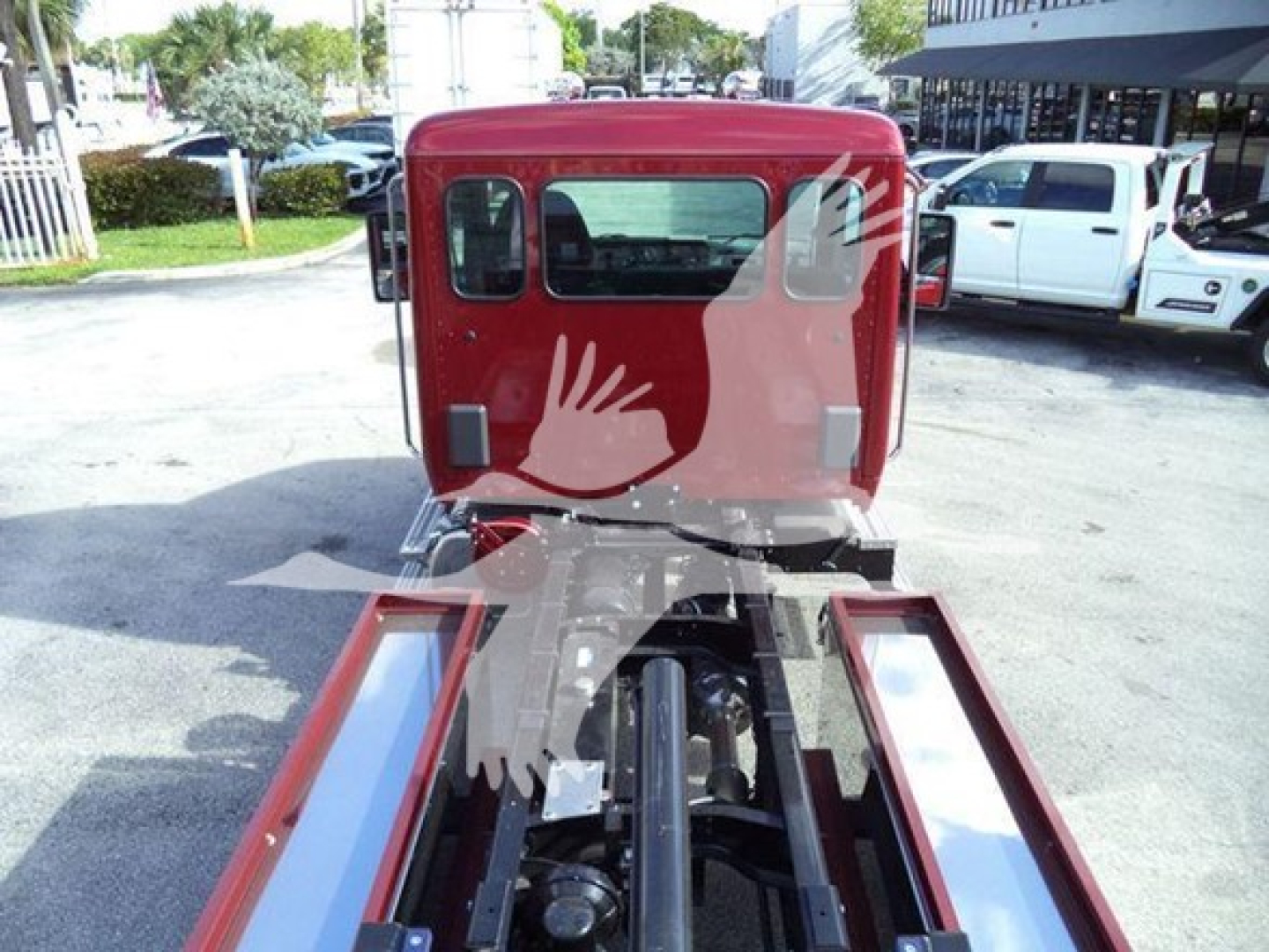 Kenworth T280 rollback truck cab rear view showing red cab and chassis with dual side rails.