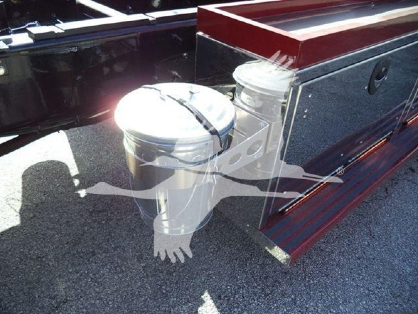Truck rollback body with dual toolboxes and chrome fuel cap showing fuel filler area.