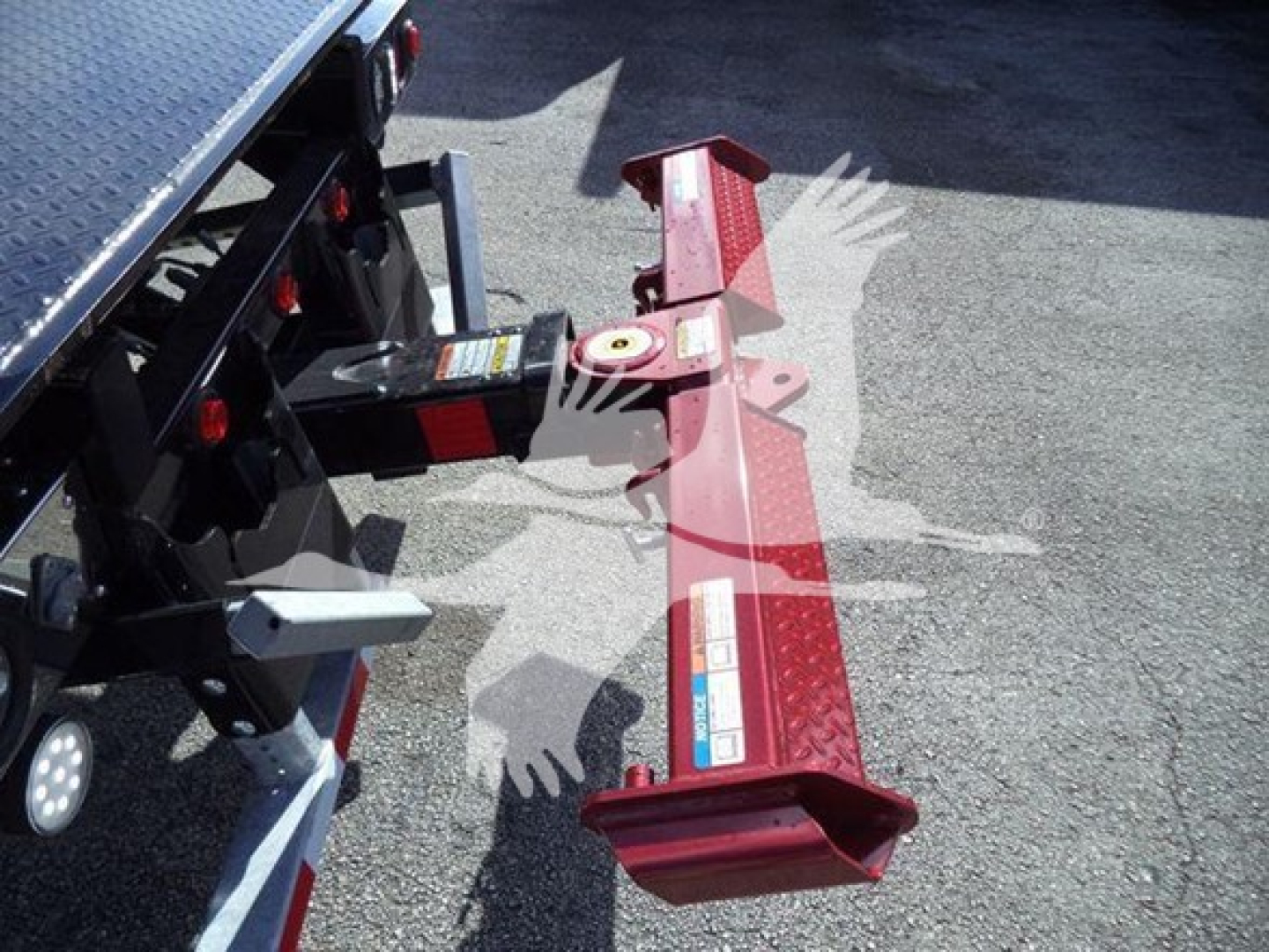 Kenworth T280 rollback truck hitch and rear frame showing hitch mechanism and red reflective bumper.