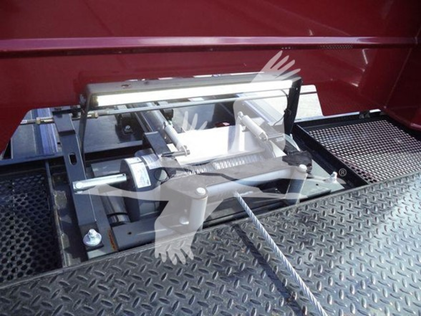 Kenworth truck rollback setup with mounted hitch/bracket assembly and platform steps.