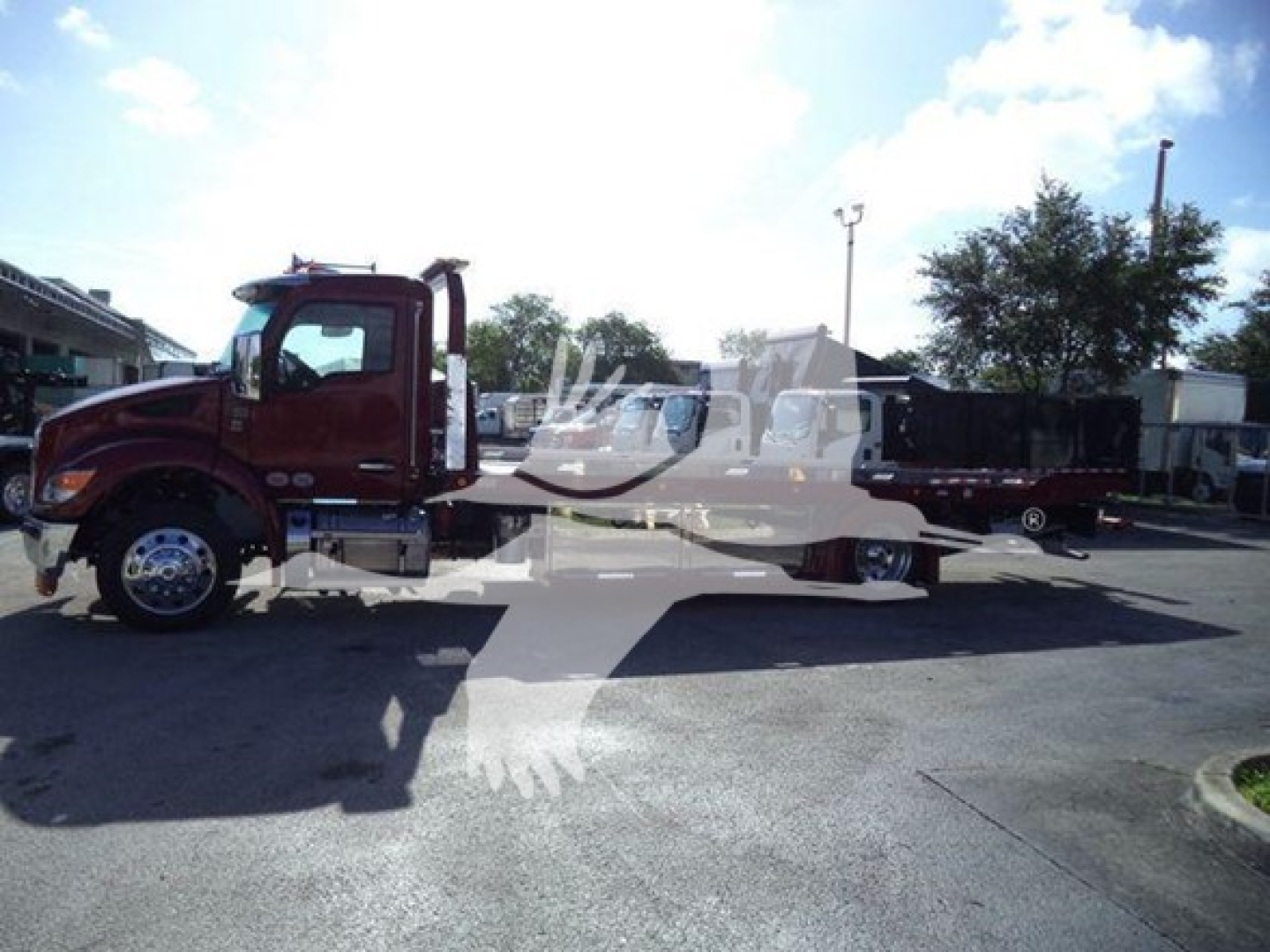 Kenworth T280 rollback truck in side profile with long flatbed, cab and chassis text not legible.