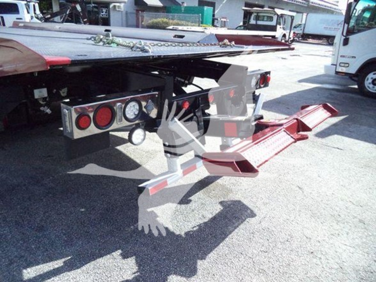 Kenworth T280 rollback truck rear with hydraulic ramps and bumper under carriage.