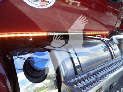 Kenworth engine bay showing DEF/Diesel exhaust fluid or fuel tank cap and step surface with chrome trim.