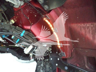 Kenworth T280 rollback truck engine bay view showing wiring harness and side panel with VIN sticker area