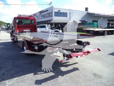 Kenworth T680 rollback tow truck flatbed with red cab and long loading bed; rear view shows tow equipment and warning stripes; VIN/stock not visible on text.