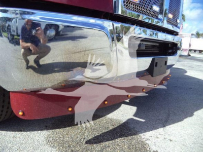 Front bumper of a 2025 Kenworth T280 rollback truck showing chrome bumper, red skid plate, and reflective surface.