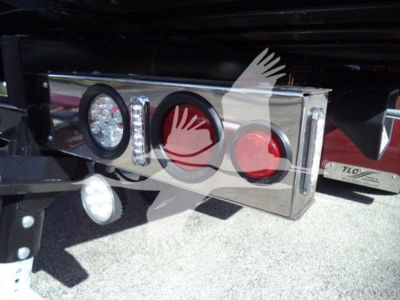 Truck rear taillights and bumper with chrome finish; visible circular lights and reflective surfaces under a hitch area.