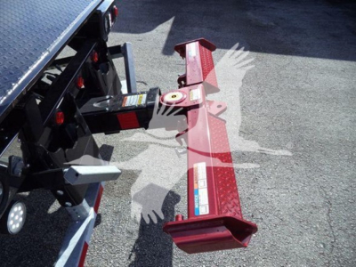 Kenworth T280 rollback truck hitch and rear frame showing hitch mechanism and red reflective bumper.