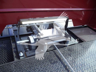 Kenworth truck rollback setup with mounted hitch/bracket assembly and platform steps.