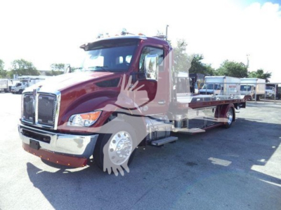 Kenworth T280 rollback truck in maroon showing front grille, cab, and long wheelbase with flatbed; chrome bumper; no visible text on side.