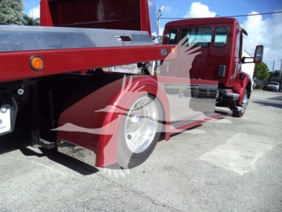Kenworth T280 rollback truck side view showing red chassis and equipment with wheel, fender, and hydraulic bed components.