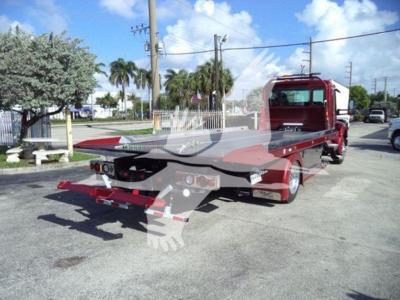Kenworth T280 rollback tow truck rear/side view showing flatbed and rear hitch; no legible model text visible.