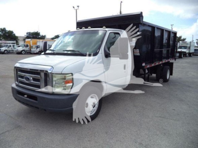 Ford E-Series cutaway truck with dump bed, white cab, black dump body, side view showing front grille and headlights.