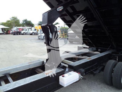 Ford E-450 dump truck bed with hydraulic lift mechanism and front water reservoir visible