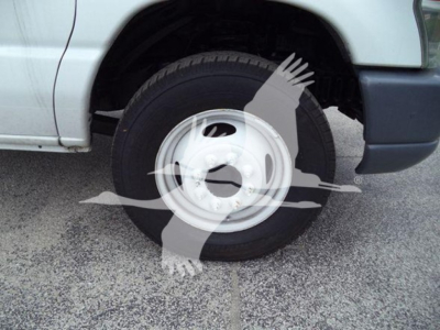 Ford E-450 truck front wheel and tire with fender; partial bumper and body visible.