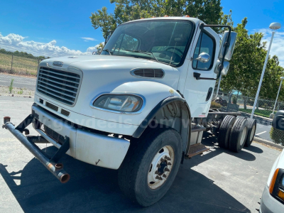 Freightliner M2 106 cab and chassis showing front view with bumper, grille, and side mirrors.