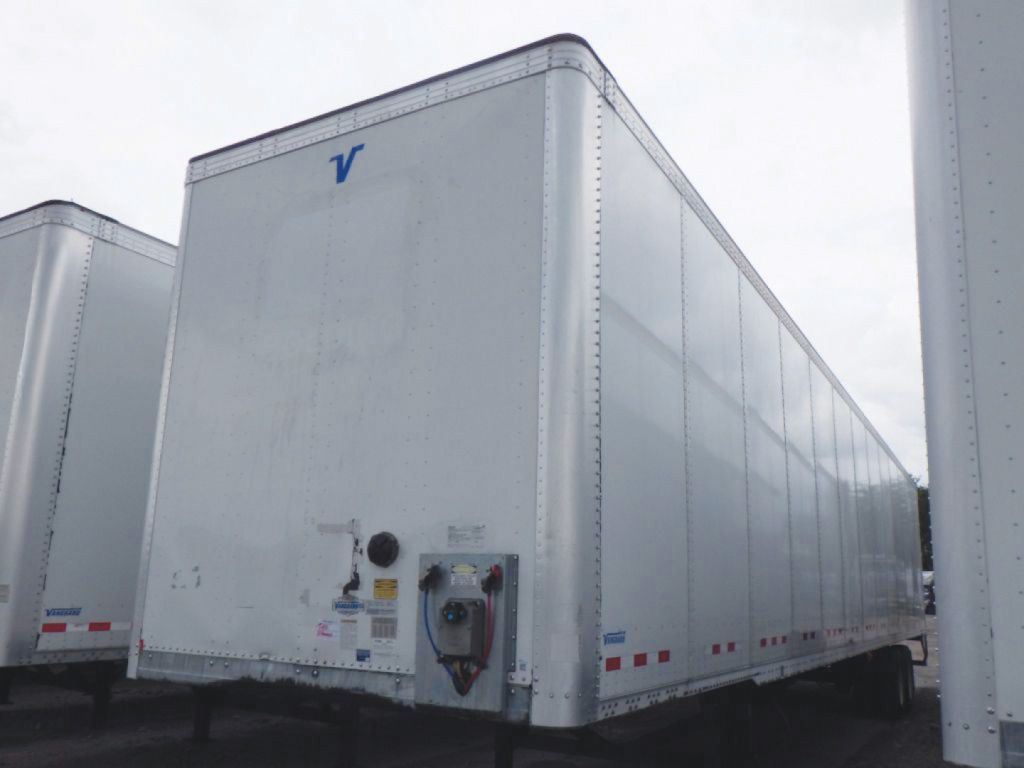 Trailer van side and rear showing white aluminum exterior with a blue Vanguard logo and rear equipment access panel.