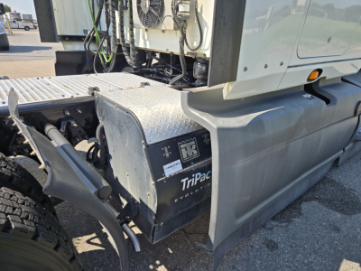 Truck cab area showing storage box with TiPaq EvoPower label and exposed drivetrain components.