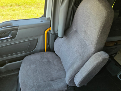 Truck cab interior with driver seat and door panel; no visible branding or text in image.