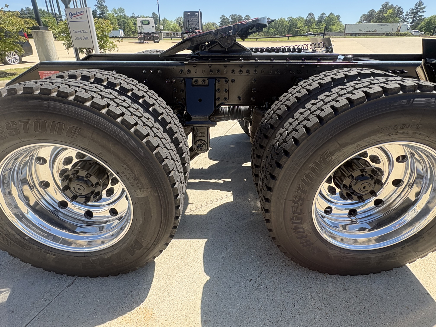  Volvo VHD64FT300 tractor rear dual rear wheels and chassis view showing dual tires and chrome rims.