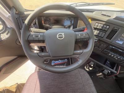 Volvo VHD64FT300 cockpit view showing steering wheel with Volvo emblem and dashboard controls