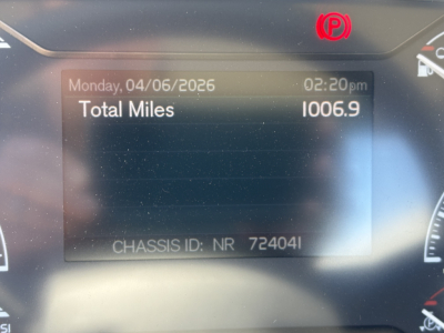 Truck dashboard display showing Total Miles 1006.9, date Monday, 04/06/2026, time 02:20 pm, chassis ID NR 724041, Volvo VHD64FT300 instruments.