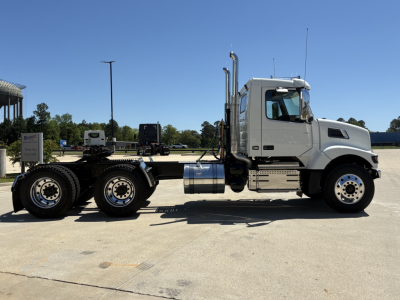 Volvo VHD64FT300 truck chassis side view showing cab, exhaust stack, fuel tanks, and dual rear axles.
