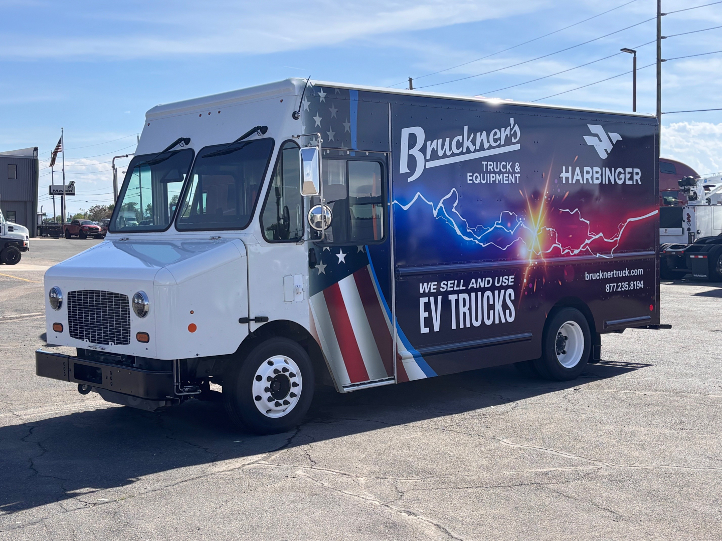 Harbinger S534 step van with Bruckner's Truck & Equipment graphics and American flag design, side view showing dealership branding and EV trucks text.