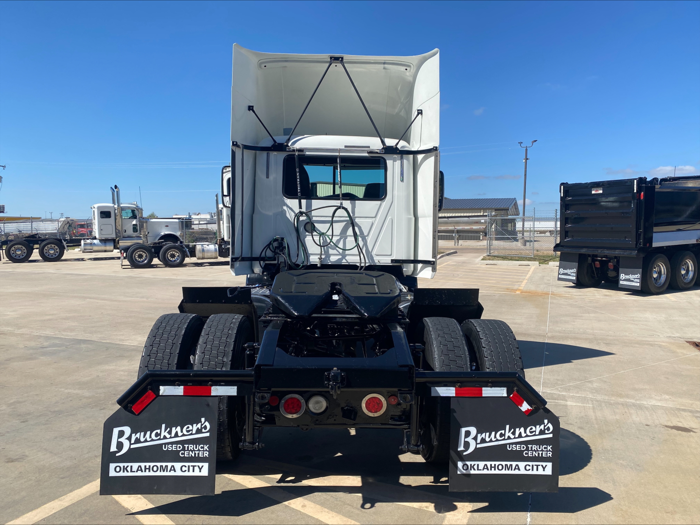 Rear view of a 2018 Mack CXU612 daycab tractor showing chassis, rear fenders, and mudflaps with Brunker’s logo; stock B3027P, VIN 1M1AW06Y7JM011085.