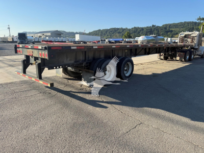 Flatbed trailer showing rear view with dual rear axles and spare tires, Fontaine XTP model features visible