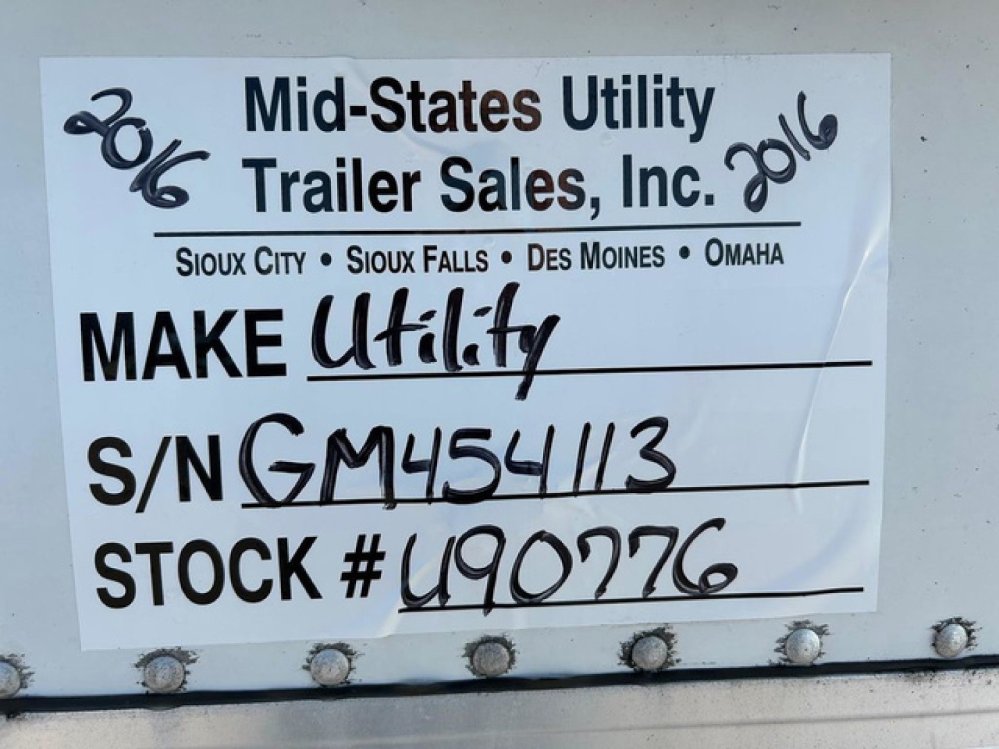 Trailer side tag showing Make Utility, S/N GM454113, Stock # U90776, Mid-States Utility Trailer Sales, Inc. with location list and 2016 handwritten year marks.