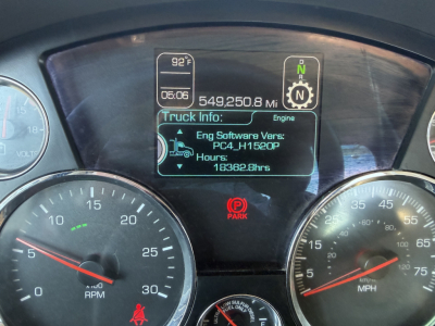 Kenworth T880 dashboard close-up showing digital display with 549,250.8 miles, engine hours 18362.8, park indicator, and truck info panel.