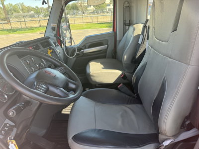 Kenworth T880 truck interior showing driver and passenger seats, steering wheel, and dashboard view.