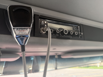Kenworth T880 interior view showing CB radio with coiled microphone and hand microphone labeled 'ASTATIC' connected to radio unit.