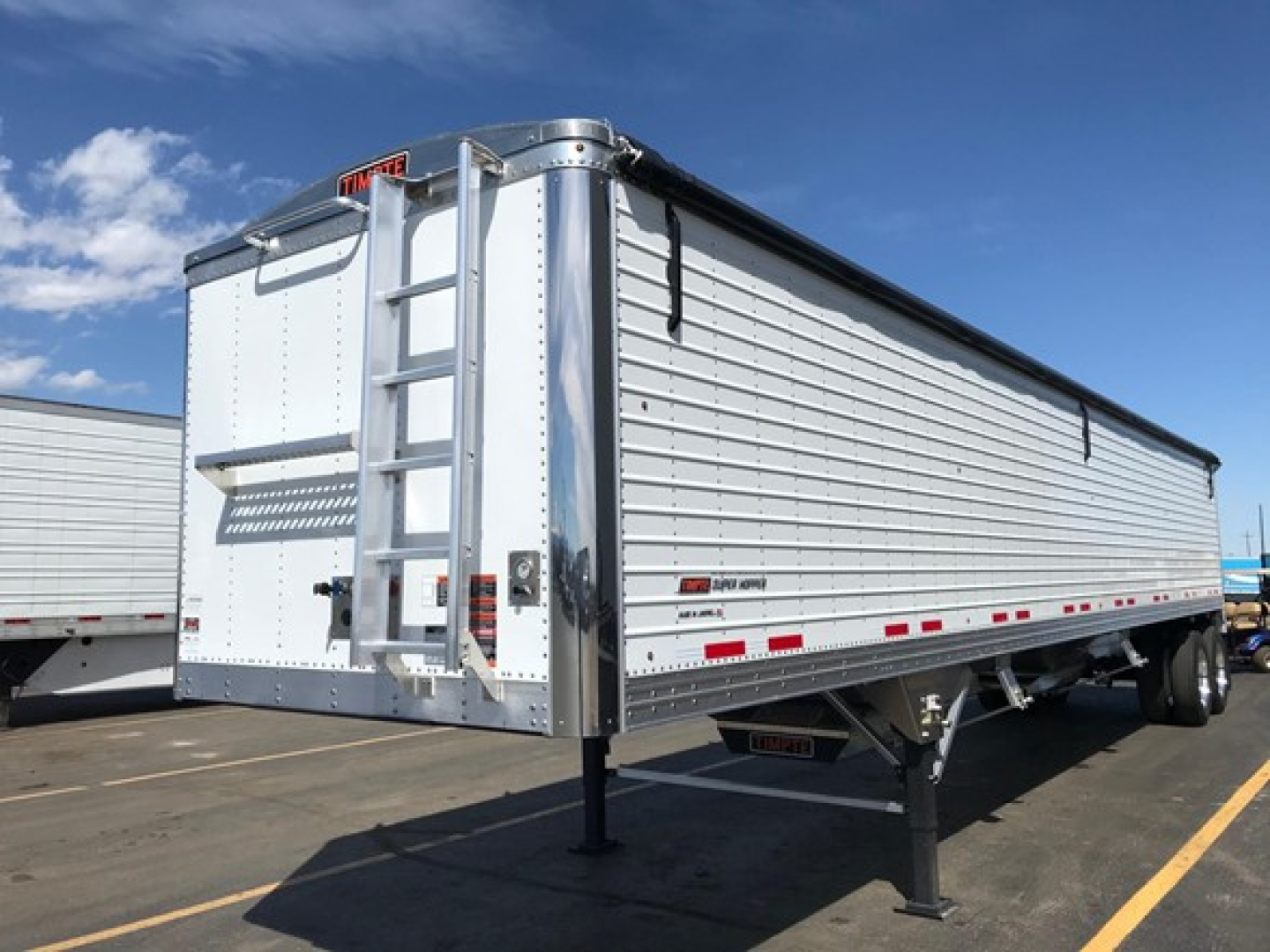 New 2026 Timpte Super Hopper trailer in silver showing side profile, rear ladder and landing gear.