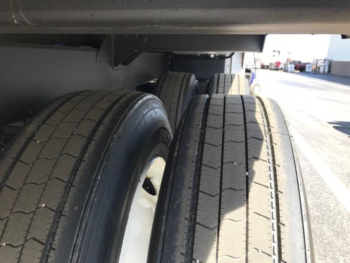 Trailer undercarriage showing dual rear axles and tire treads of a 2026 Timpte Super Hopper.