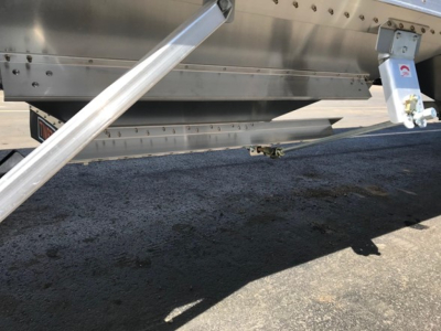 Timpte Super Hopper trailer undercarriage showing frame and support braces with hitch and wiring.