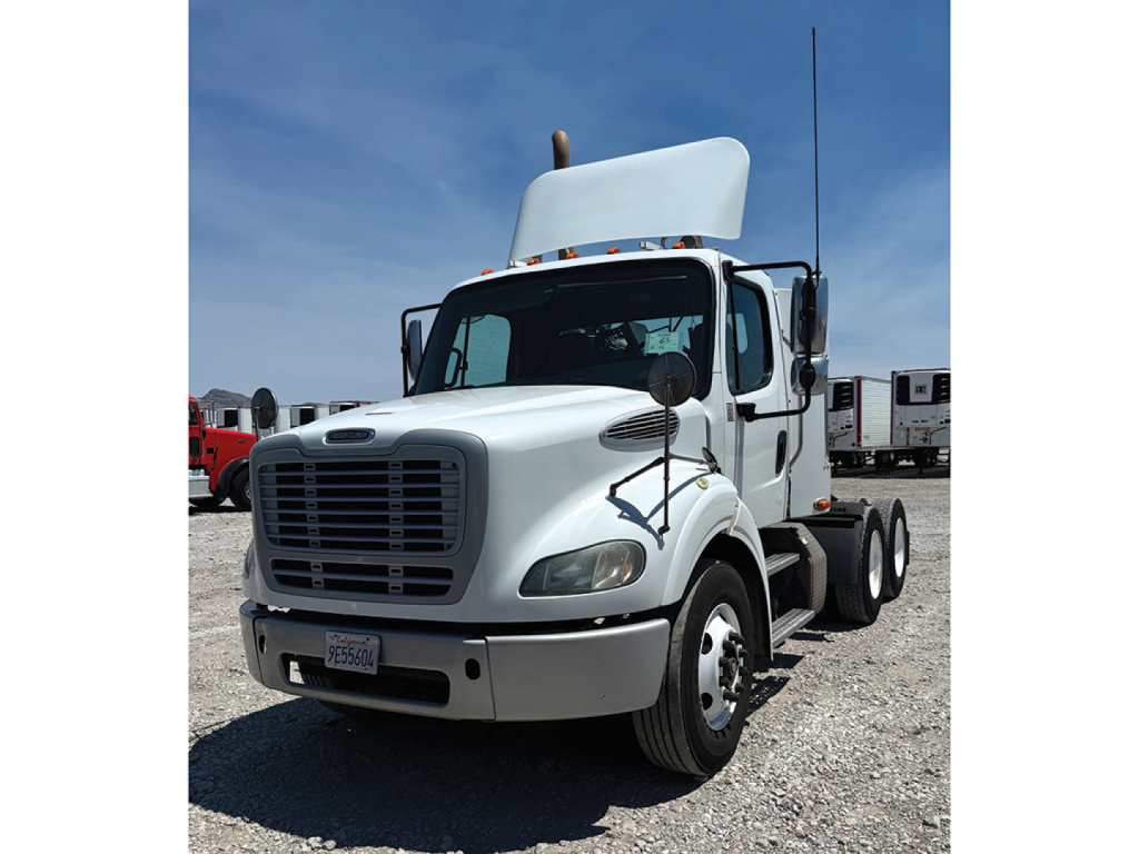 Freightliner M2 112 daycab tractor in white, front-left view with hood up and grille visible.