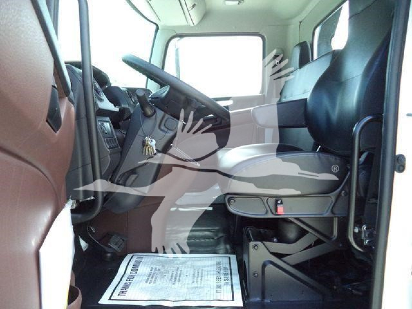 Truck cab interior side view showing driver seat and dashboard of a new 2027 Hino L6 rollback truck.