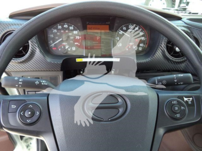 Dashboard and steering wheel of a Hino truck showing instrument cluster and steering controls