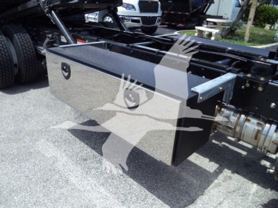 Truck chassis with a large rectangular toolbox mounted on the frame; no visible text readable on the toolbox or nearby components.