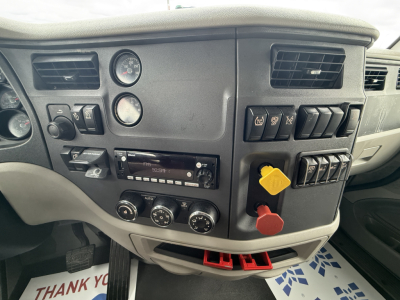 Peterbilt cab dashboard with ignition and controls; visible text on switches and gauges; no clear VIN or plate text readable in image.