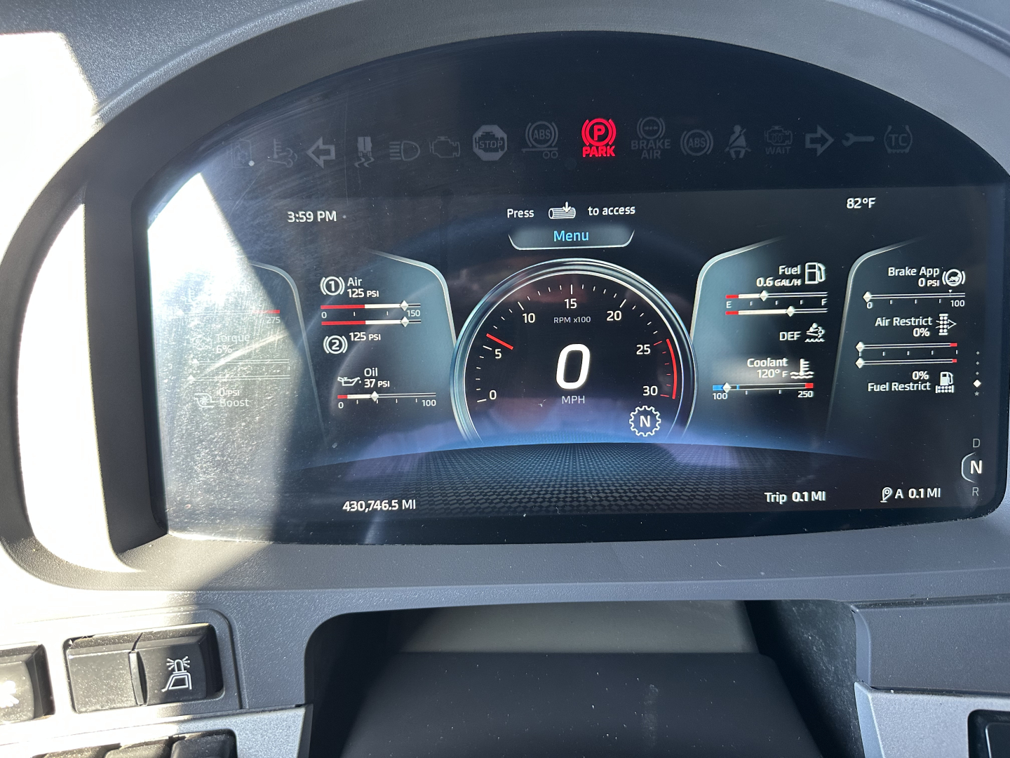 Kenworth T680 instrument cluster and digital dash displaying speedometer at 0 mph, various gauges, and warning icons.